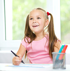 Image showing Cute cheerful child drawing using felt-tip pen