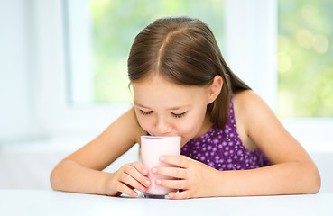 Image showing Cute little girl with a glass of milk