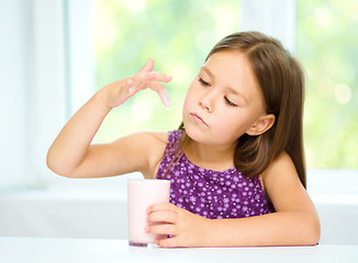 Image showing Little girl with a glass of milk