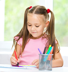 Image showing Cute cheerful child drawing using felt-tip pen