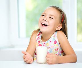 Image showing Cute little girl with a glass of milk