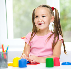 Image showing Girl is having fun while playing with plasticine