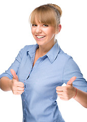 Image showing Woman is showing thumb up gesture