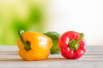 Image showing Colorful peppers on a wooden table