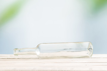 Image showing Glass bottle on a wooden table