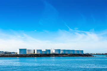 Image showing Silo facilities by a blue ocean