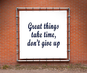 Image showing Large banner with inspirational quote on a brick wall