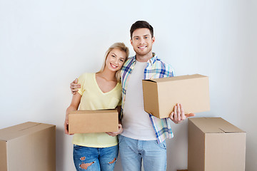 Image showing smiling couple with big boxes moving to new home