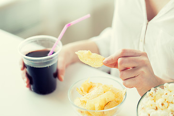 Image showing close up of woman with junk food and coca cup