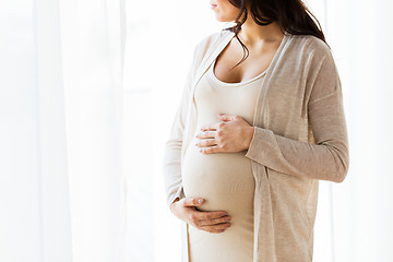 Image showing close up of pregnant woman looking to window
