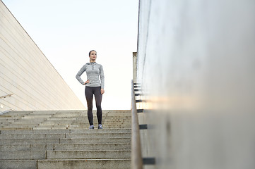 Image showing sporty woman standing on in city stairs