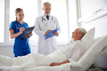 Image showing doctor and nurse visiting senior woman at hospital