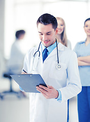 Image showing male doctor writing prescription