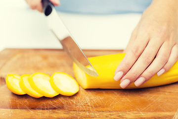 Image showing close up of hands chopping squash with knife