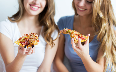 Image showing happy friends or teen girls eating pizza at home