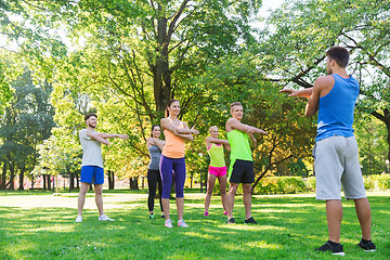 Image showing group of friends or sportsmen exercising outdoors