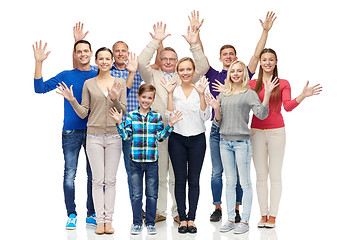 Image showing group of smiling people waving hands
