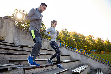 Image showing couple running downstairs on stadium