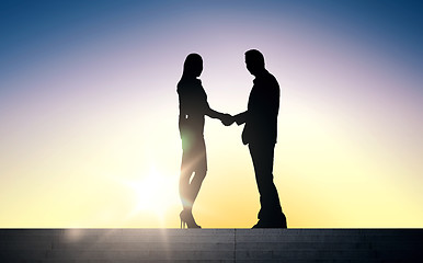 Image showing business partners silhouettes shaking hands