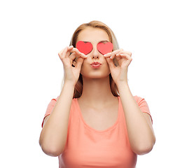 Image showing happy young woman with red heart shapes on eyes