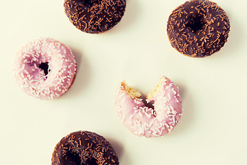 Image showing close up of glazed donuts pile over white