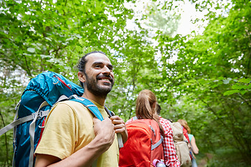 Image showing group of smiling friends with backpacks hiking