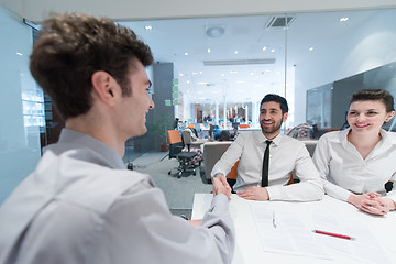 Image showing young couple signing contract documents on partners back