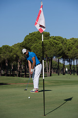 Image showing golf player hitting shot at sunny day