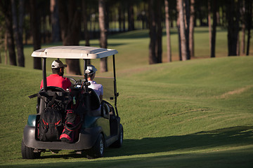 Image showing couple in buggy on golf course