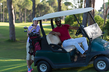 Image showing couple in buggy on golf course