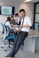 Image showing young business man with tablet at office meeting room