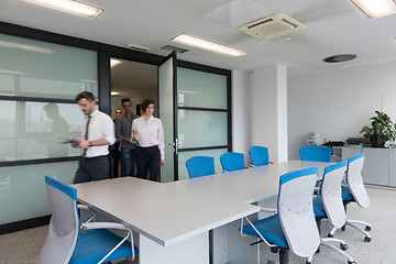 Image showing business people group entering meeting room, motion blur