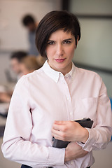 Image showing hispanic businesswoman with tablet at meeting room