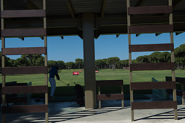 Image showing golf player practicing shot on training