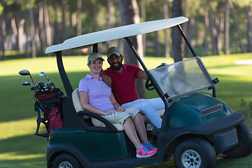 Image showing couple in buggy on golf course