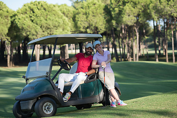 Image showing couple in buggy on golf course