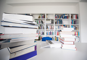 Image showing female student study in library, using tablet and searching for 