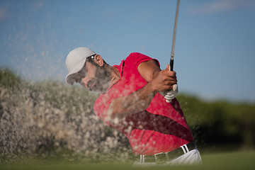 Image showing golfer hitting a sand bunker shot