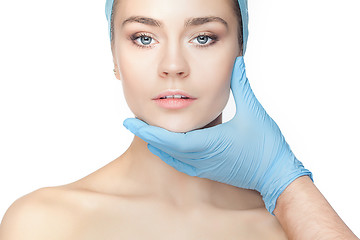 Image showing Plastic surgery concept. Doctor hands in gloves touching woman face