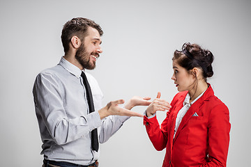 Image showing The business man and woman communicating on a gray background