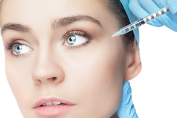 Image showing Attractive woman at plastic surgery with syringe in her face