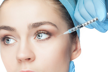 Image showing Attractive woman at plastic surgery with syringe in her face