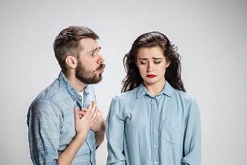 Image showing The young couple with different emotions during conflict