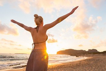 Image showing Free Happy Woman Enjoying Sunset on Sandy Beach