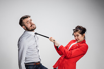 Image showing Woman leading a man by his tie