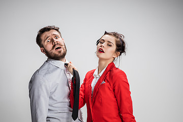 Image showing Woman leading a man by his tie