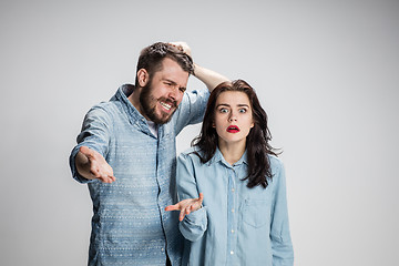 Image showing The young couple with different emotions during conflict