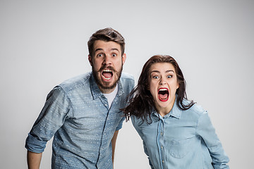 Image showing The screaming man and woman on gray