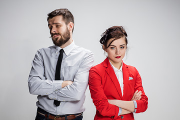 Image showing The sad business man and woman conflicting on a gray background