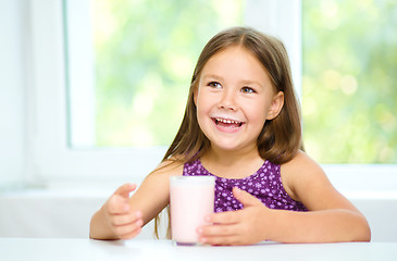 Image showing Cute little girl with a glass of milk